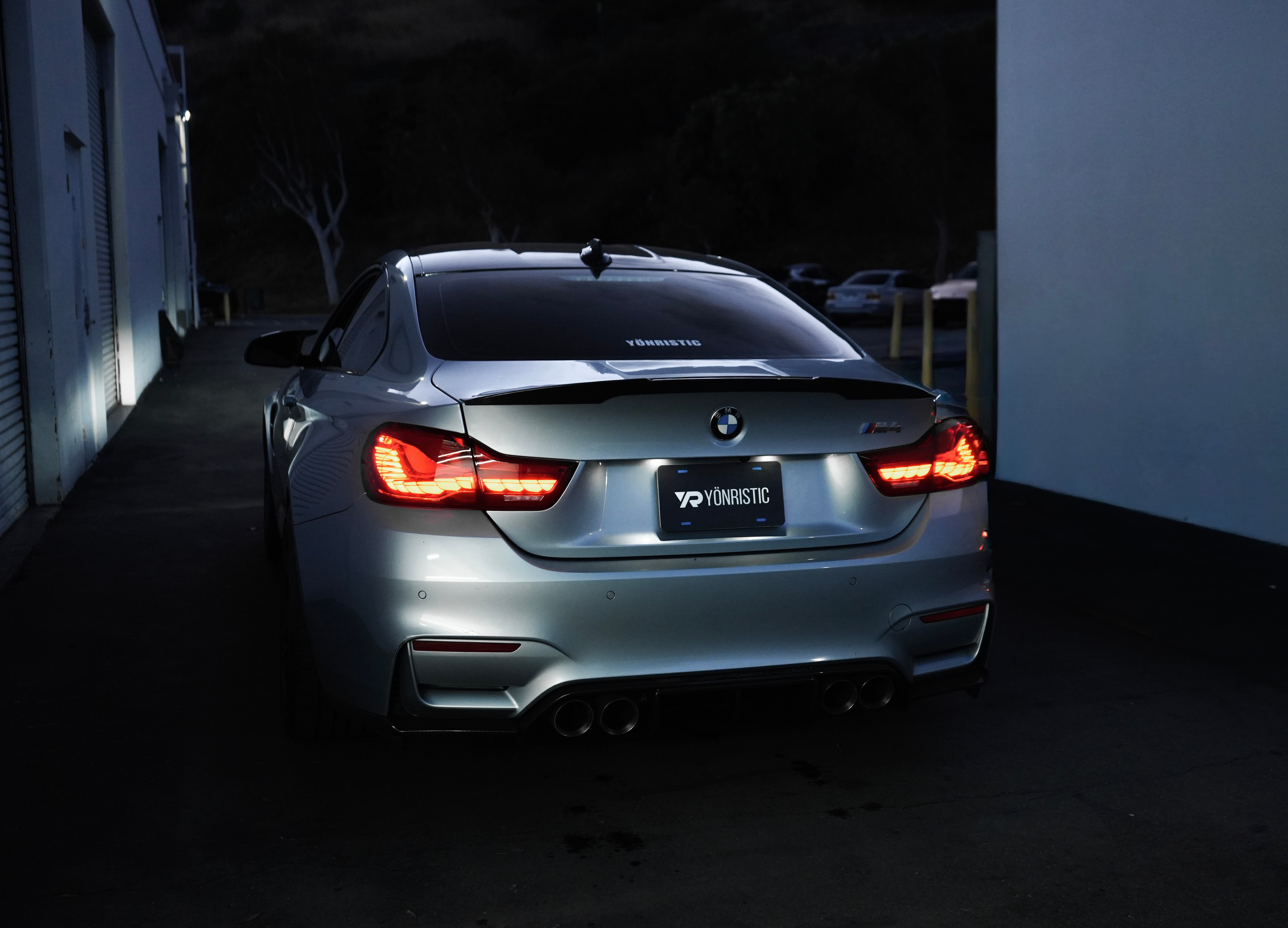 BMW G8X with Yonristic exhaust in a cinematic garage setting